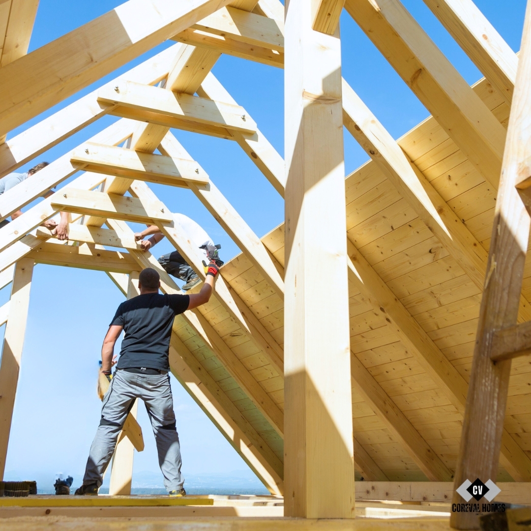 roof builders mounting prefabricated wooden roof construction for custom home build